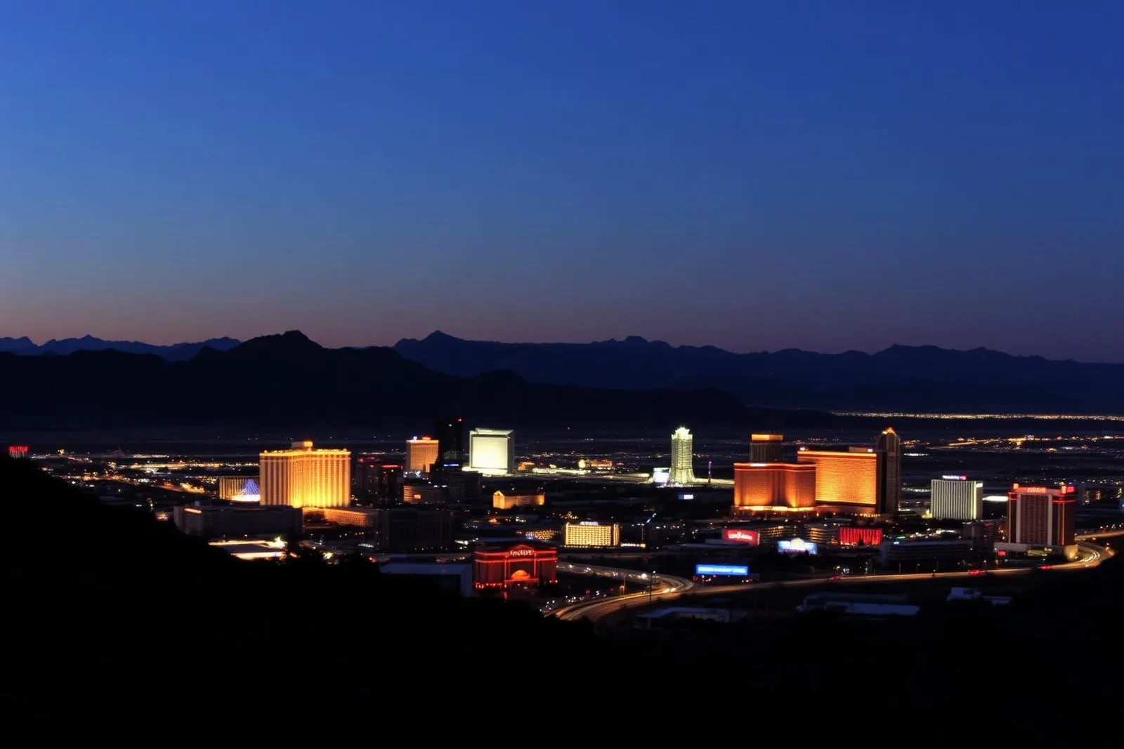 Las Vegas Valley at dusk with city lights spreading toward the mountains